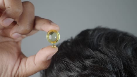 applying hair oil capsule