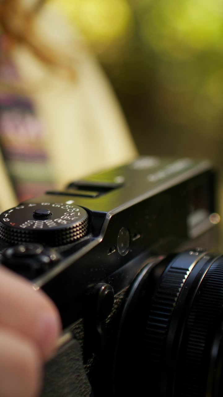 Hands Adjusting Settings on a Camera