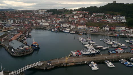 establishing drone shot over scarborough town harbour on overcast day