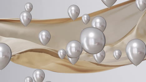 animation of silver balloons floating over gold and white background