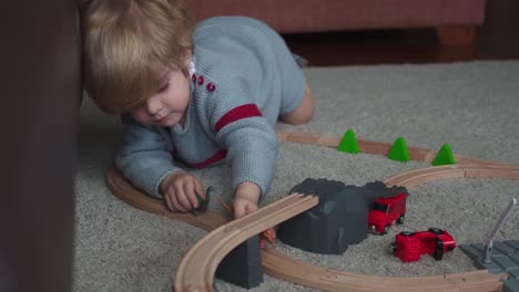 little boy playing with dinosaurs