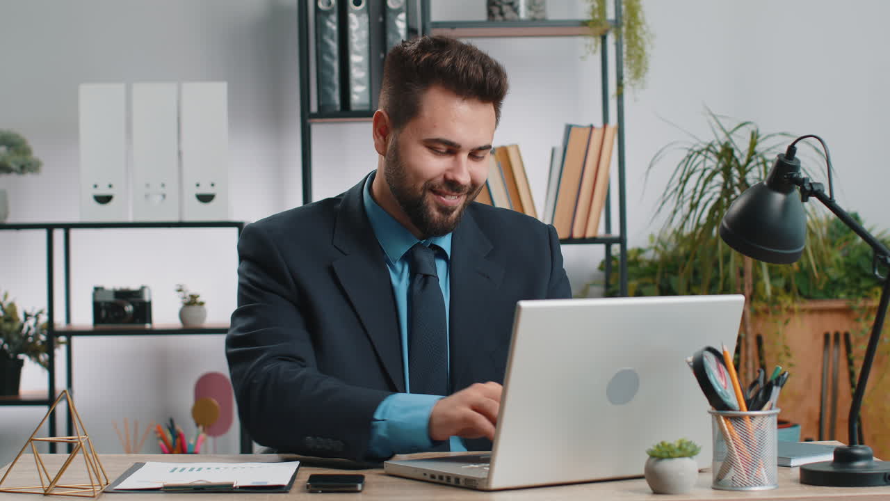 Caucasian business man freelancer at office start working on laptop computer sends online messages