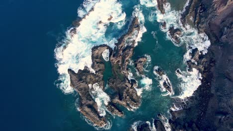 top view of rocks arounded by waves in canary island