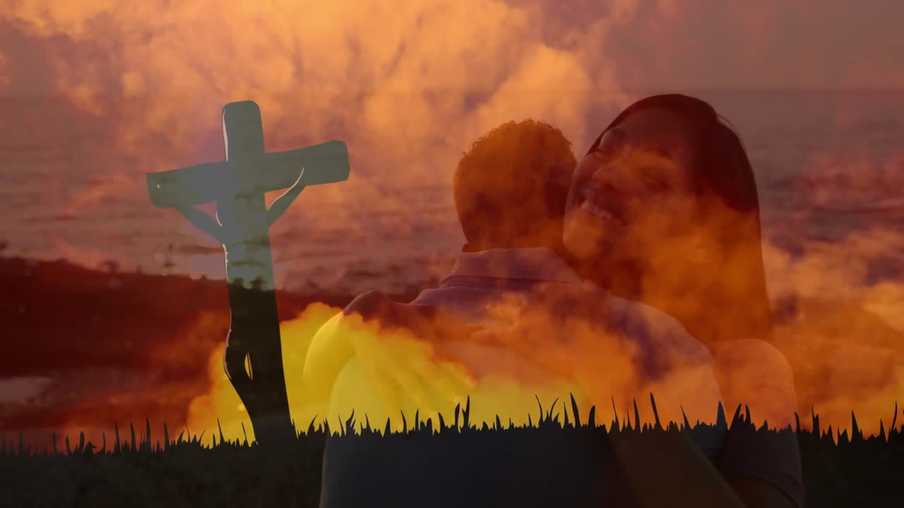 Sunset cross remaining as dissolve effect revealing couple hugging grassy hill reflecting faith