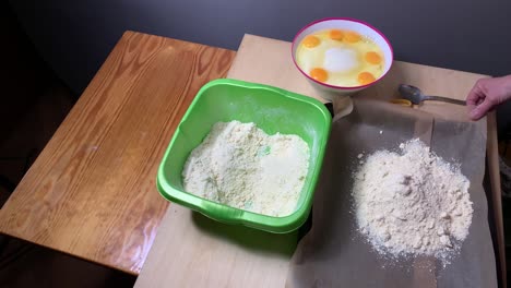 static: carefully putting pie base on baking tray aside bowl of egg mass