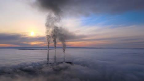 coal power plant high pipes with black smoke moving upwards polluting atmosphere. production of electrical energy with fossil fuel concept