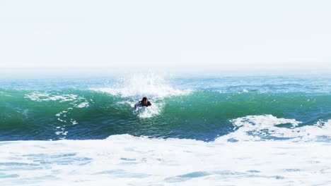 surfers surfing in sea