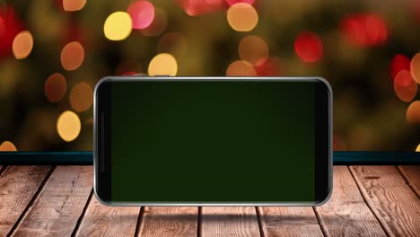 animation of blank smartphone screen on wooden surface over flickering fairy lights
