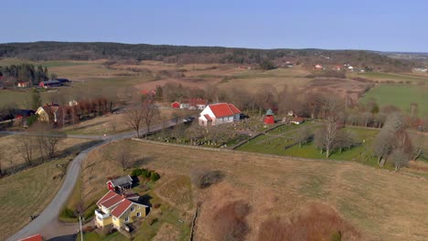 aerial - church and cemetery in countryside, bergum, sweden, wide shot forward