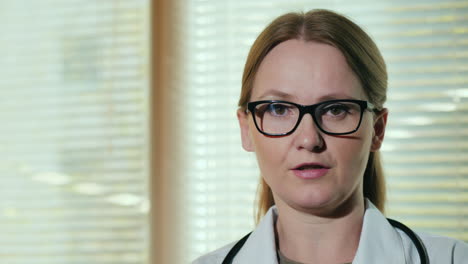 portrait of a female doctor speaking to the camera