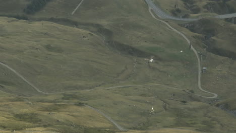 Loaded-helicopter-going-down-in-a-valley-french-alps-mountains-maintenance