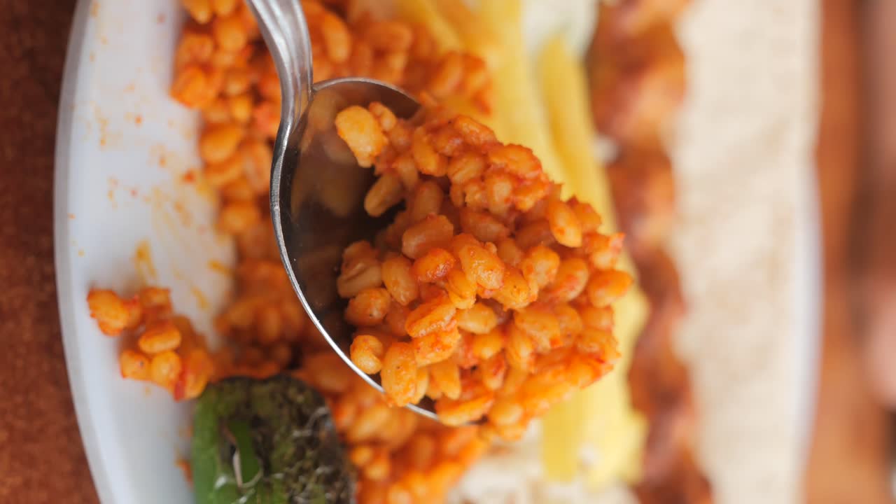 Close-up of a spoon full of bulgur pilaf