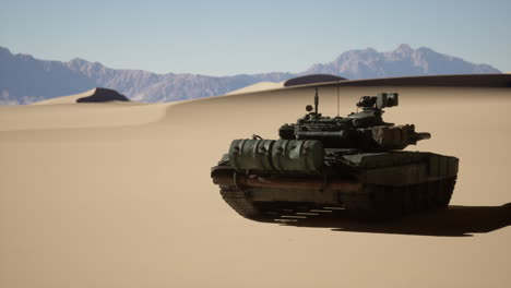 tank driving through desert with mountains in background