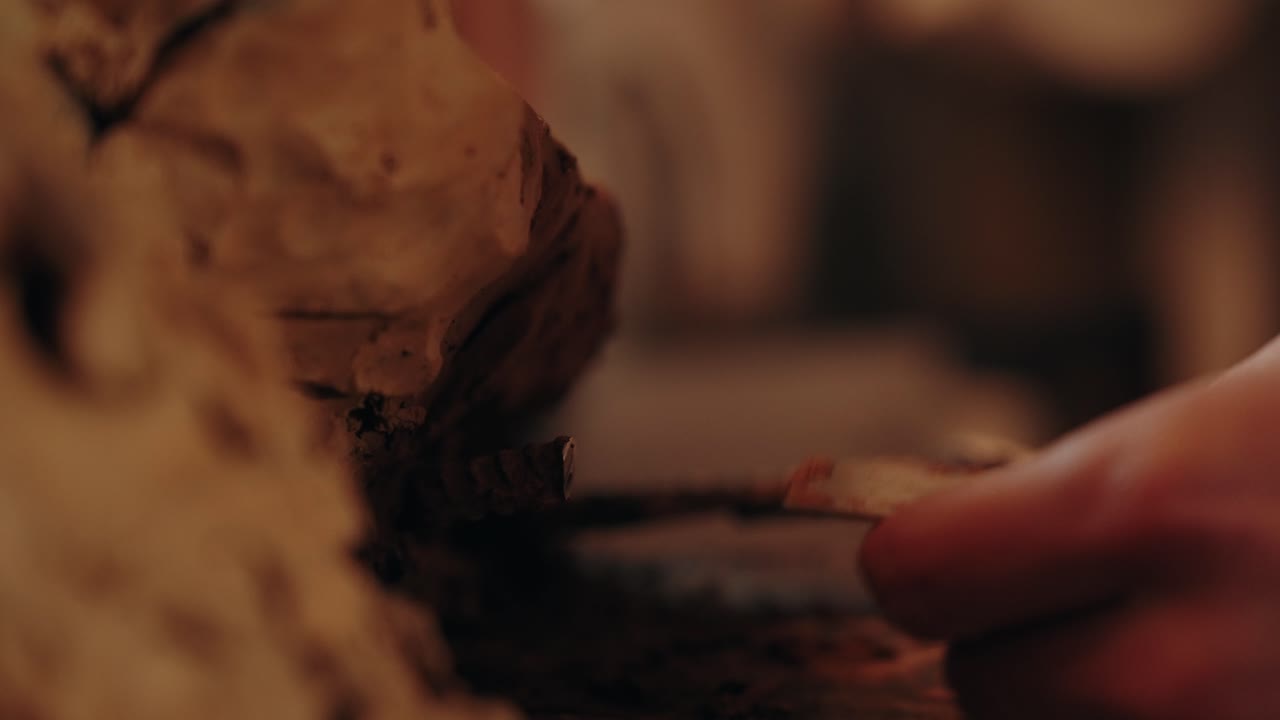 close up of male hands shaping clay with care in warm rustic environment