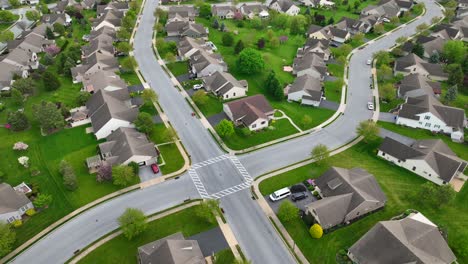 vista aérea de un pintoresco barrio suburbano con céspedes bien cuidados, casas bien arregladas y calles que se cruzan
