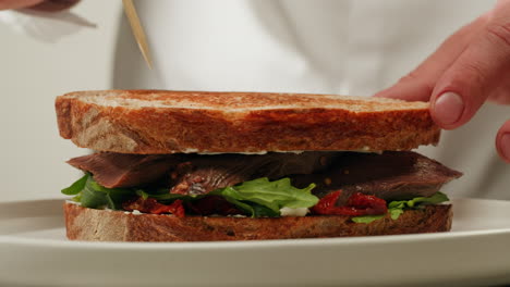 chef preparing a delicious tongue sandwich