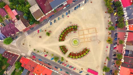 Top-aerial-panoramic-view-of-Lowicz-old-town-historical-city-centre-with-Rynek-Market-Square,-Old-Town-Hall,-New-City-Hall,-colorful-buildings-with-multicolored-facade-and-tiled-roofs,-Poland