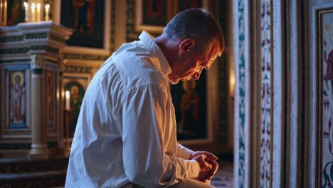 man praying in a church