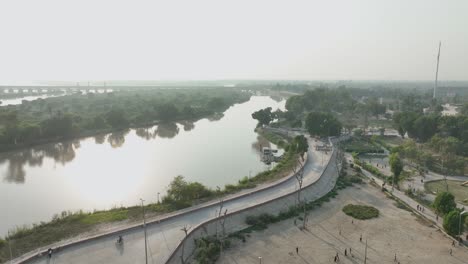 curved road along indus river, sukkur, sindh - aerial