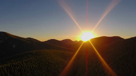 sunset over mountainous forest