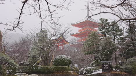 snow falling over kiyomizu dera temple in kyoto japan