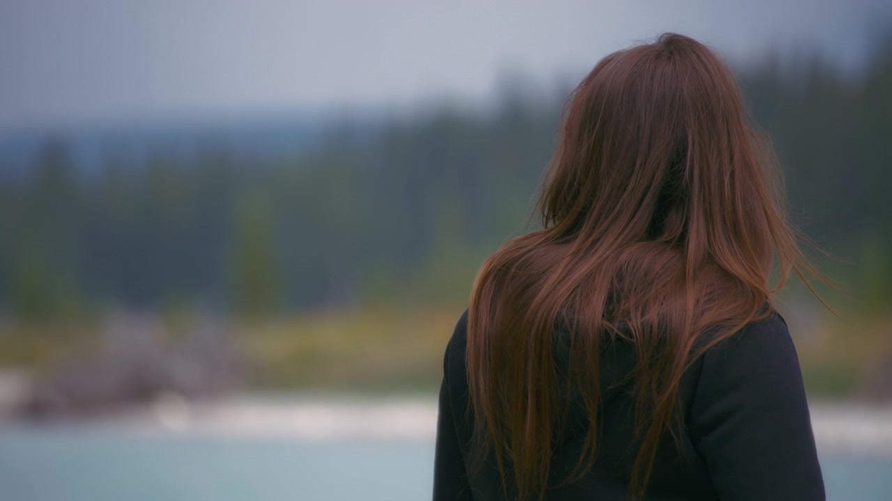 Back shot of a woman looking at the scenic landscape