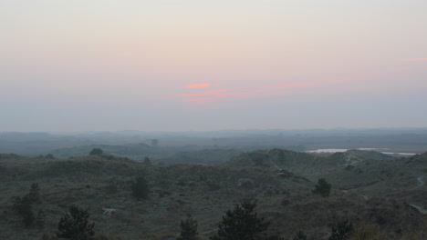 Background-of-sunset-or-sunrise-over-wild-hills-at-dusk-or-dawn