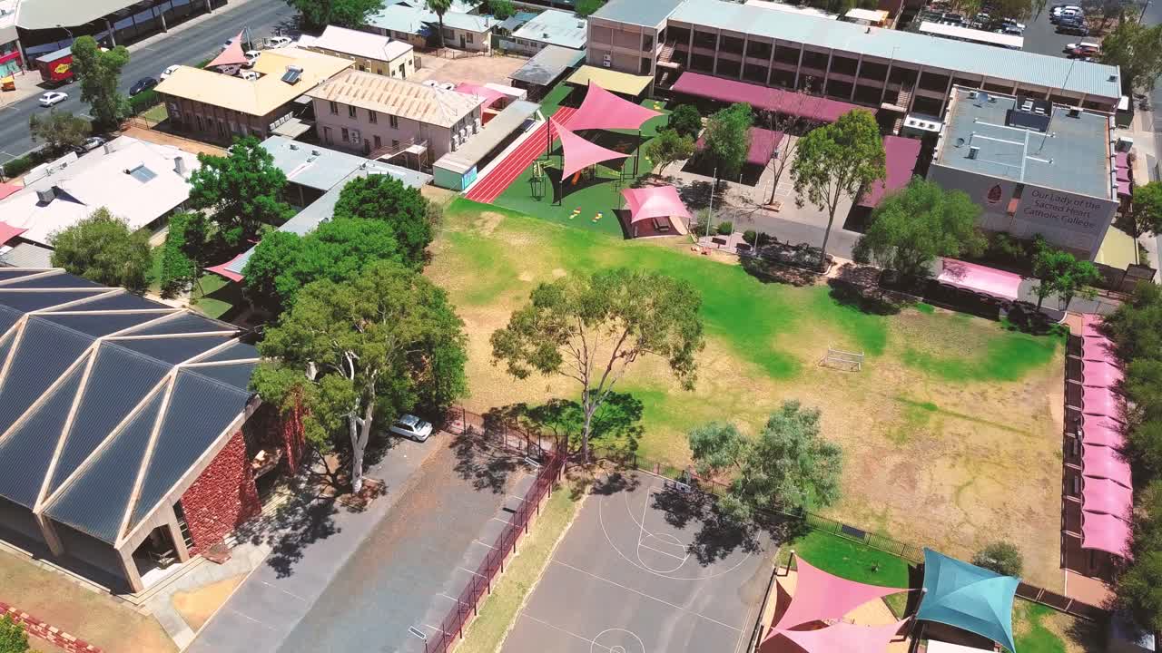 Alice Springs - Australia. Cinematic aerial push in towards Our Lady of the Sacred Heart Catholic College campus. Filmed on DJI Mavic Pro