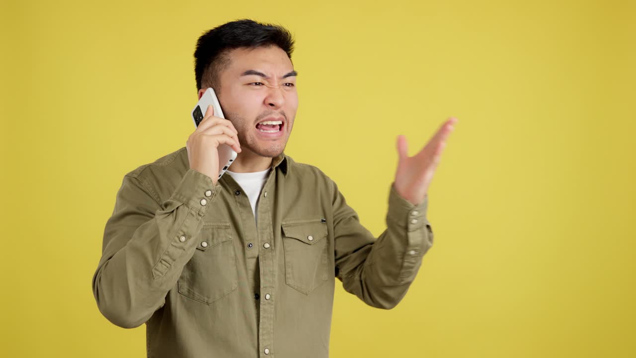 Asian Man Engaged in an Expressive Phone Conversation Showing Various Emotions