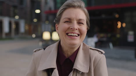 portrait-of-middle-aged-business-woman-laughing-cheerful-enjoying-evening-commuting-in-city-wearing-stylish-coat