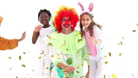 Animation-of-gold-confetti-over-diverse-happy-children-and-clown-at-party,-waving,-on-white