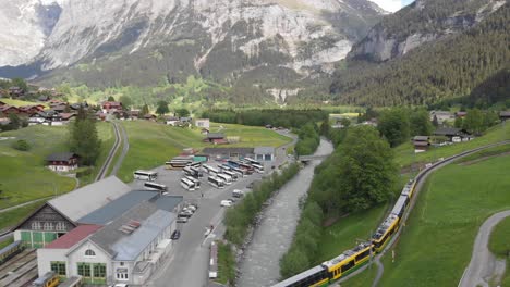 aerial of a train crossing a bridge in a mountainous valley