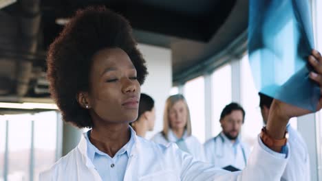 close-up view of african american young doctor looking at x-ray scan in hospital