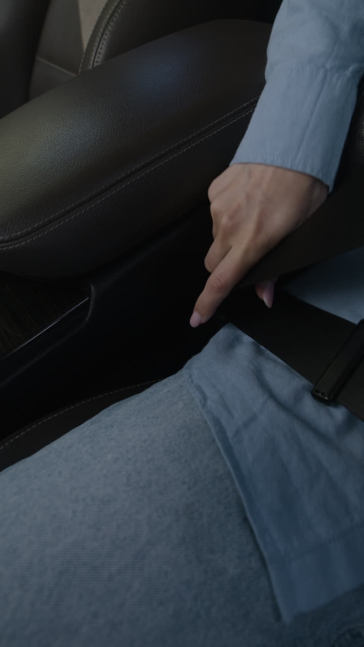 Putting on a seatbelt in a car