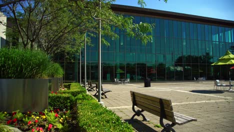 whitby public library square with available seating outside on wooden benches