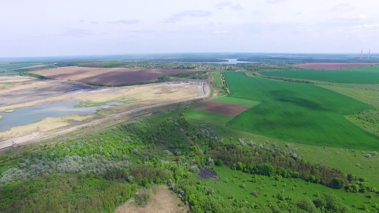 Aerial view of nature. Aerial view on green and yellow parts of fields and countryside