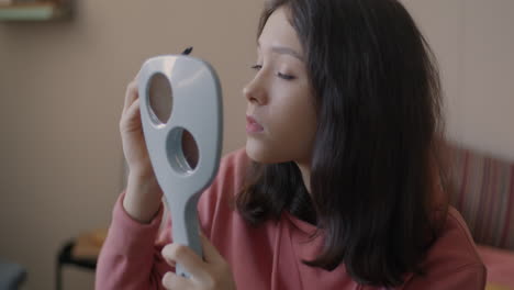 teenage girl applying mascara