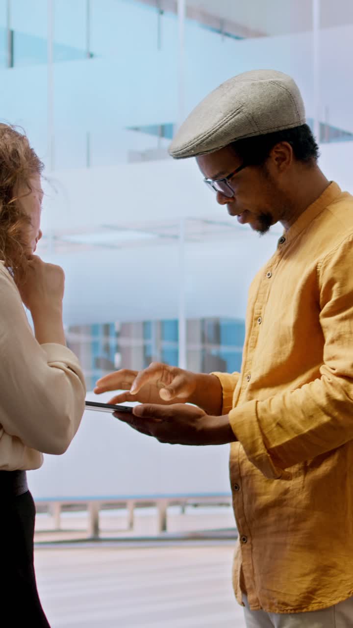 Business Colleagues Discussing Project on Digital Tablet in Modern Office