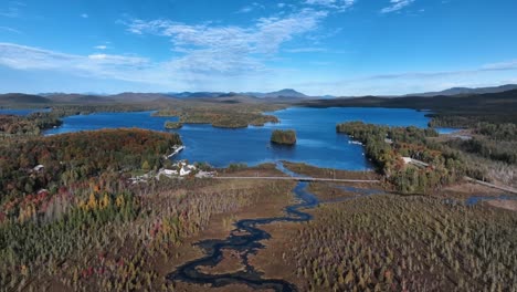 raquette lake village with river, islands and mountain views in summer in hamilton, new york