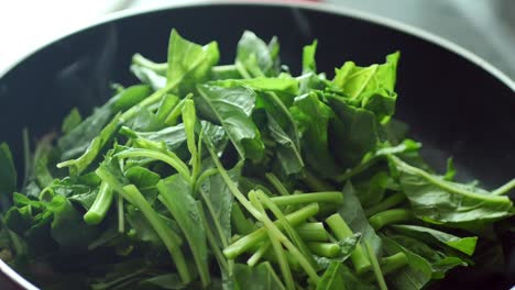 cooking spinach in a pan