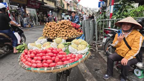 vendor with fruit baskets on a busy street