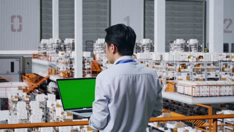 warehouse worker using laptop