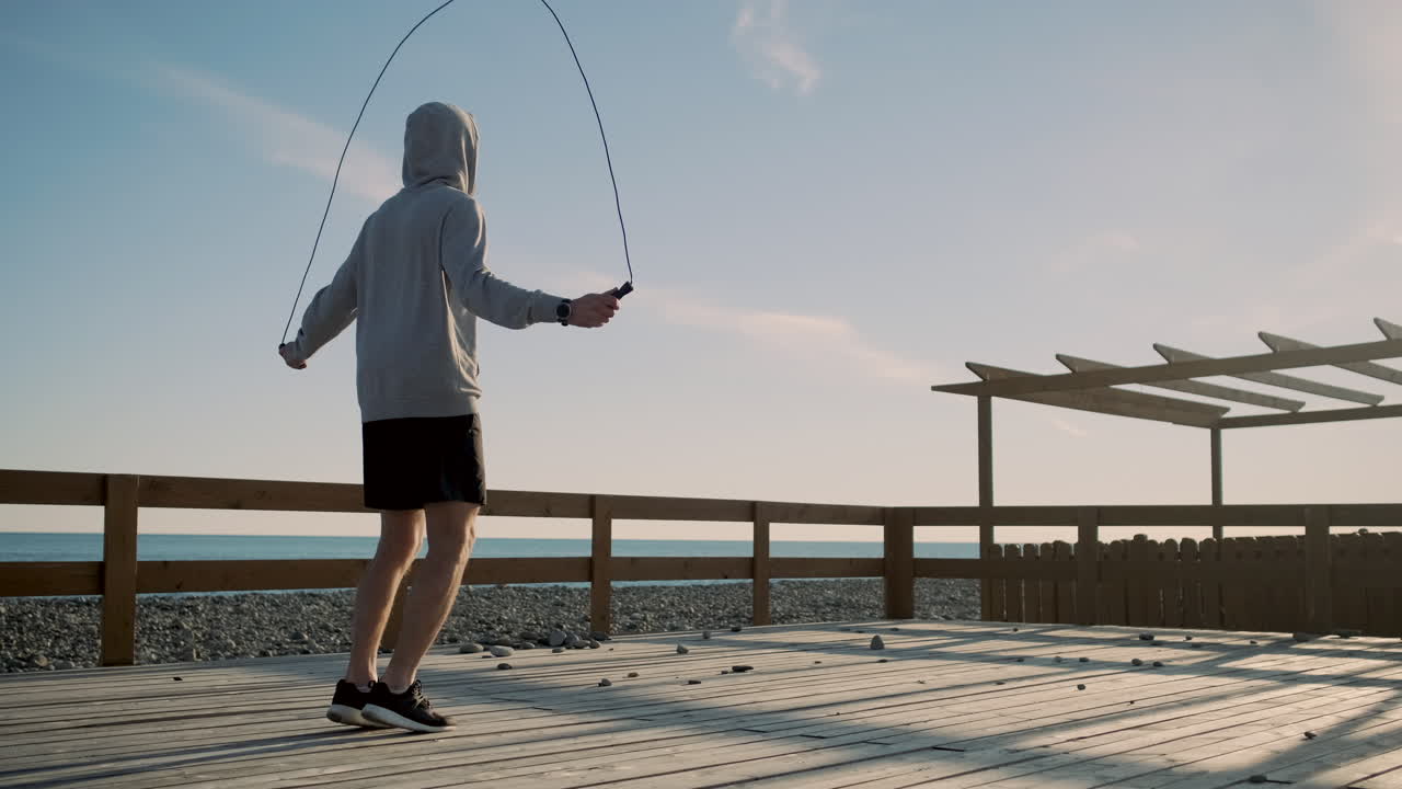 Man Skipping Rope on a Beach Dock