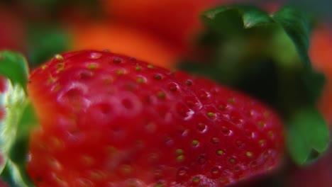 macro detailed video of a pile of strawberries, red raw strawberry, green leaf, tiny seeds, on a rotating stand, smooth movement, slow motion 120fps