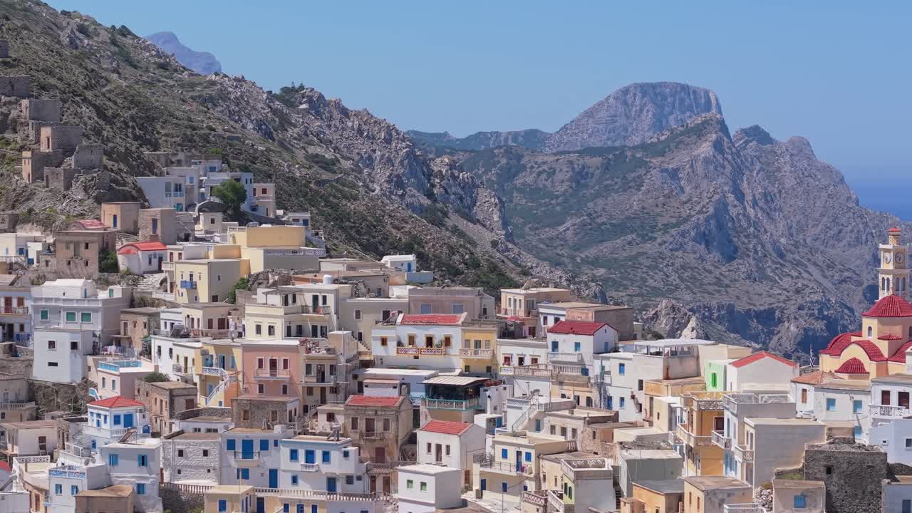 Drone footage reveals Olympos village in Karpathos from the hillside and edge, showcasing its stunning location, traditional houses, and the scenic mountainous landscape