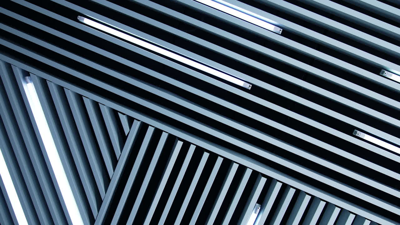 White day light lamps as the element of room décor. Unusual design of the ceiling with white planks and illumination.