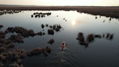 person kayaking through serene delta waters at sunset