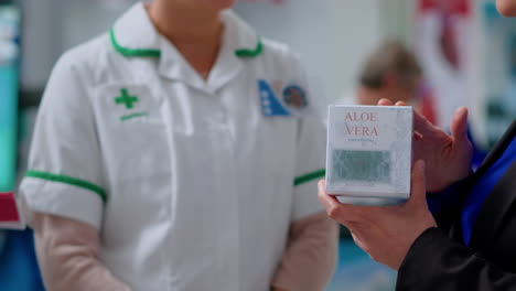 pharmacist offers customer aloe vera