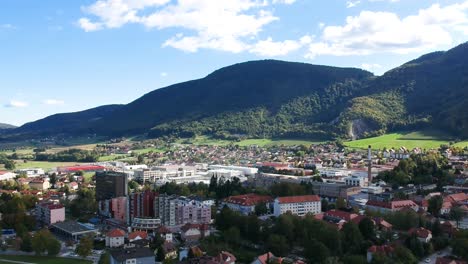 double speed fly over town surrounded by mountains and forests aerial