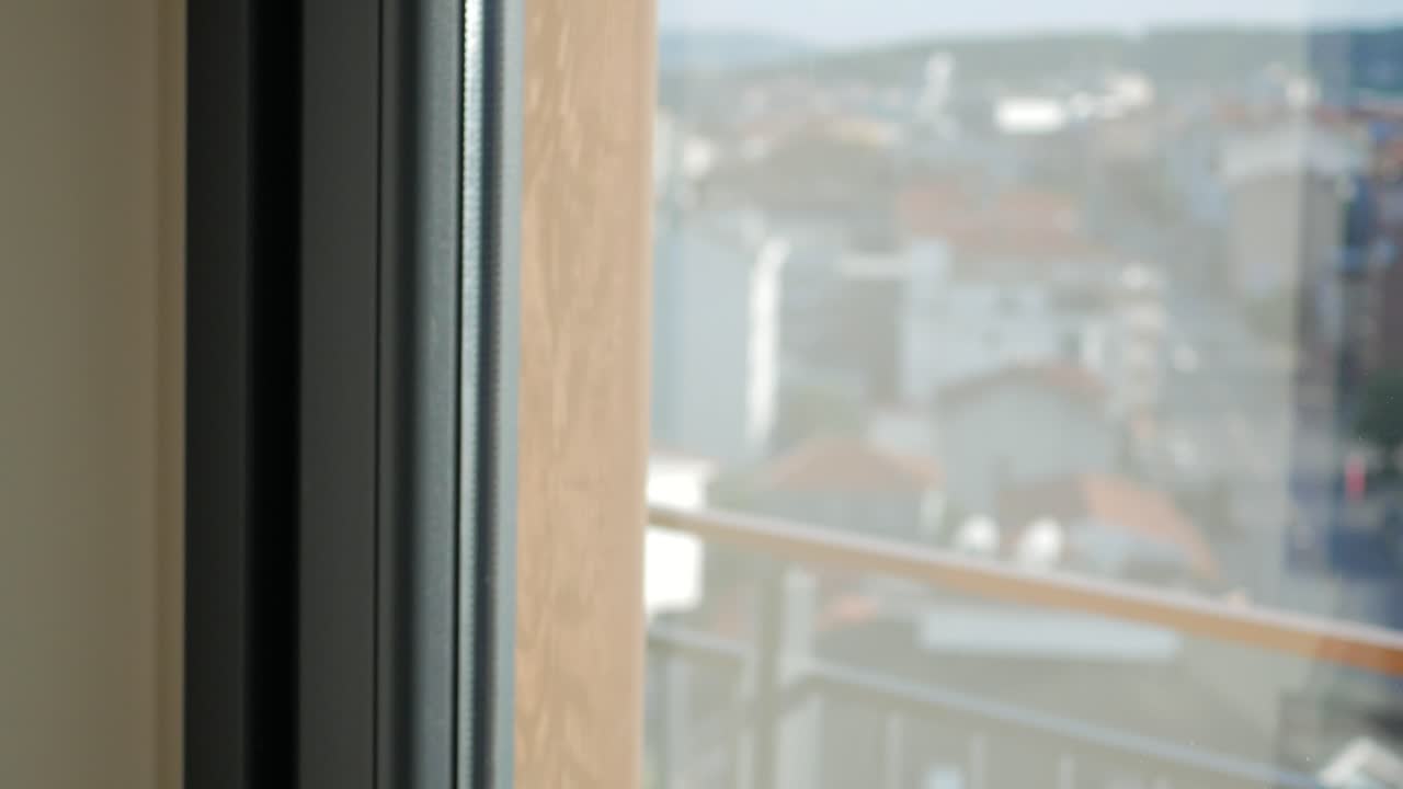 Person opening window curtain